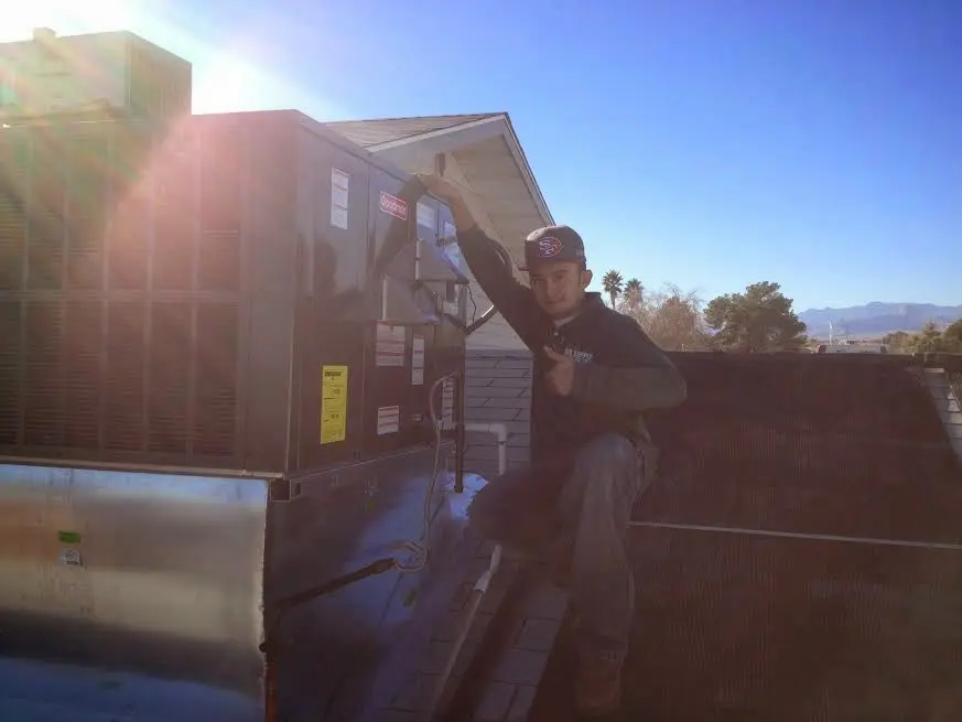 HVAC technician performing HVAC Inspection on a rooftop unit in La Habra